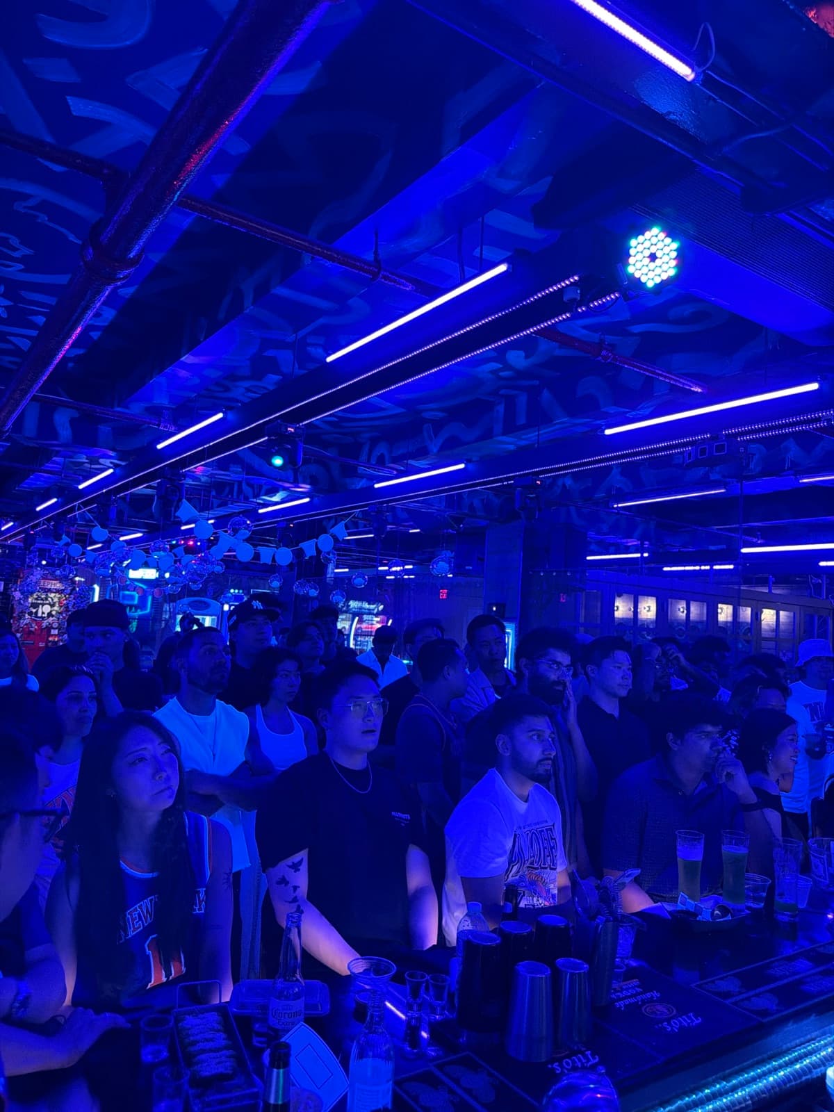 Guests enjoying a Space Ping Pong night under blue lights